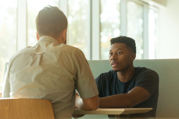 Two people having a conversation about spiritual matters.
